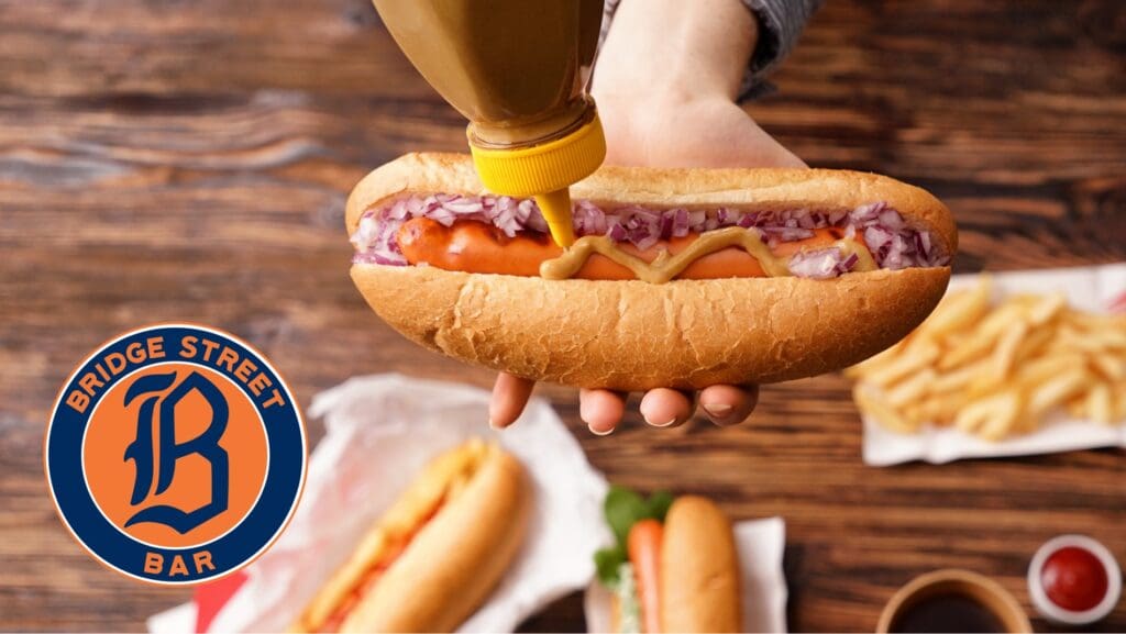Bridge Street Bar serving a hot dog as part of the fundraiser that helps support local families.