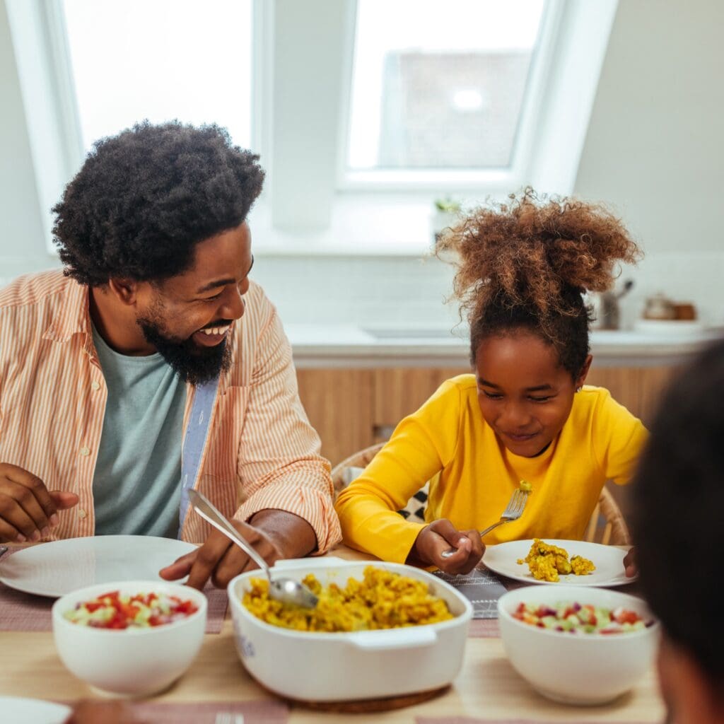 Parents and children receiving meal support at Family Promise shelter